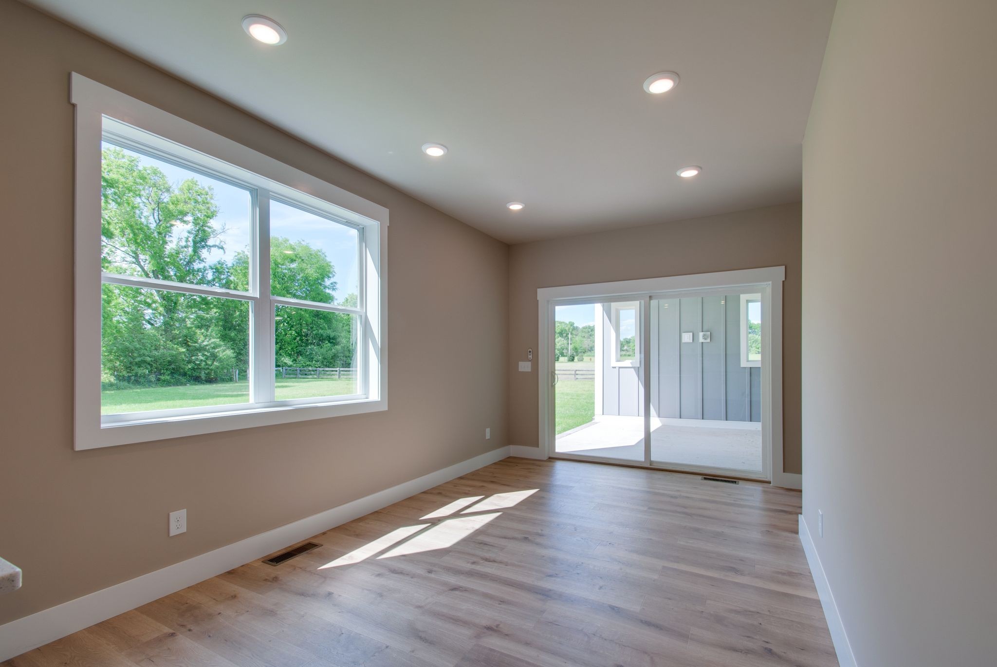 1151 Canaan Road Columbia, TN 38401 - Photo 19 of 40 a view of an empty room with wooden floor and a window