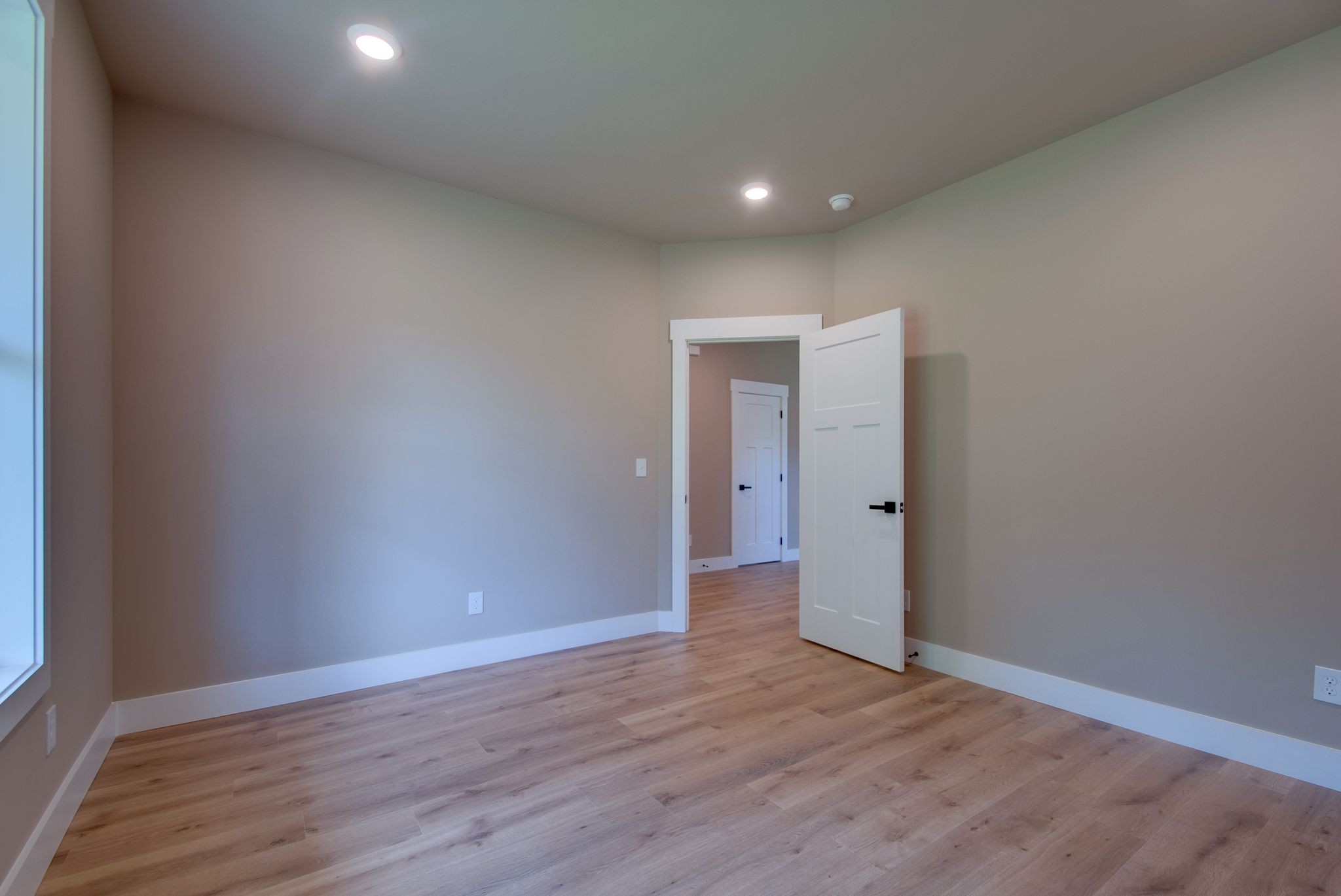 1151 Canaan Road Columbia, TN 38401 - Photo 7 of 40 a view of an empty room with wooden floor and a window
