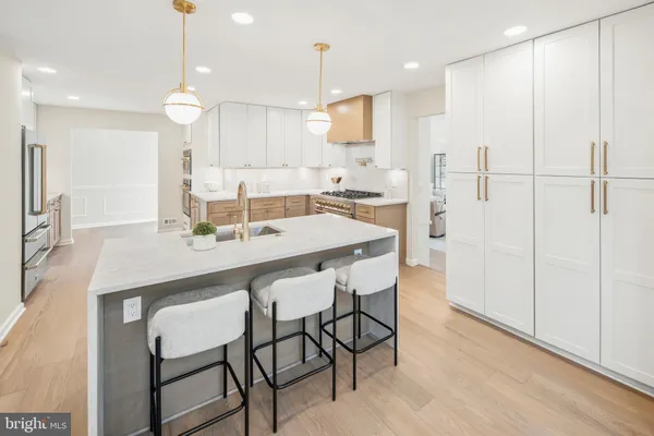 a kitchen with stainless steel appliances granite countertop a stove a sink dishwasher and a refrigerator with wooden floor