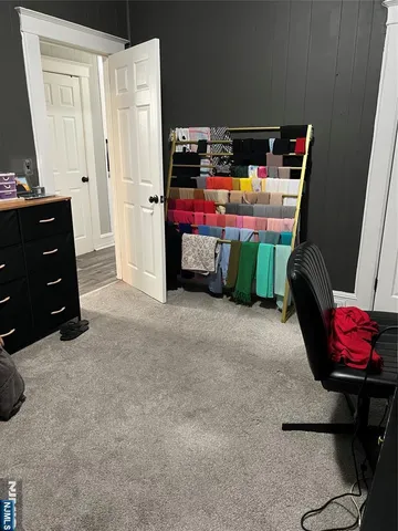 a kitchen with kitchen island granite countertop a stove top oven a sink a dining table and chairs with wooden floor