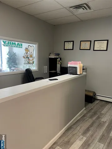 a view of a livingroom with furniture and flat screen tv