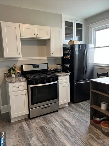 a stove top oven sitting inside of a kitchen