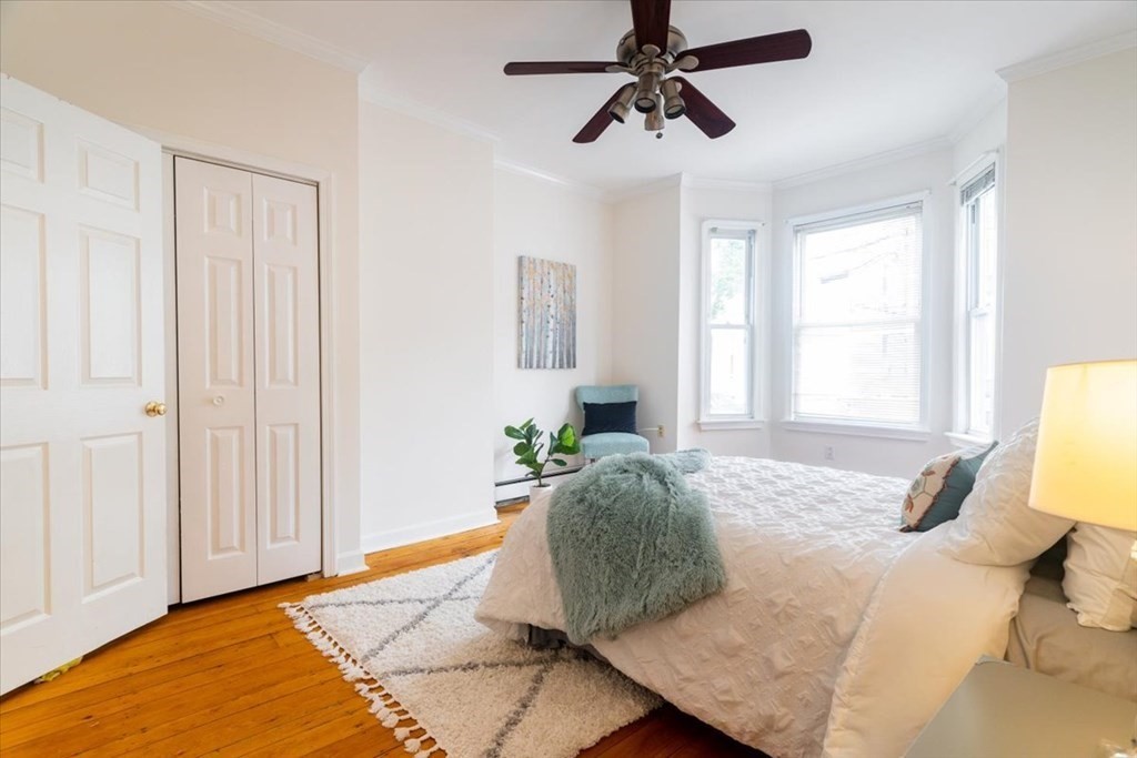 245 West Fifth Street, Unit 2 Boston, MA 02127 - Photo 11 of 34 a bedroom with a bed and wooden floor