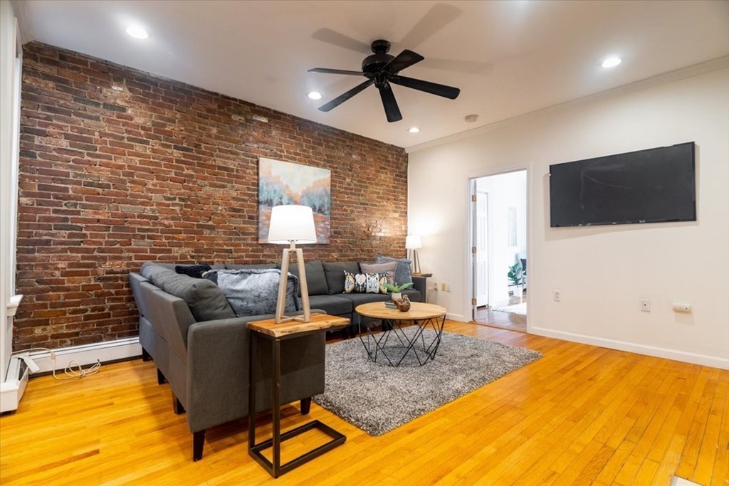 245 West Fifth Street, Unit 2 Boston, MA 02127 - Photo 2 of 34 a living room with furniture and a flat screen tv