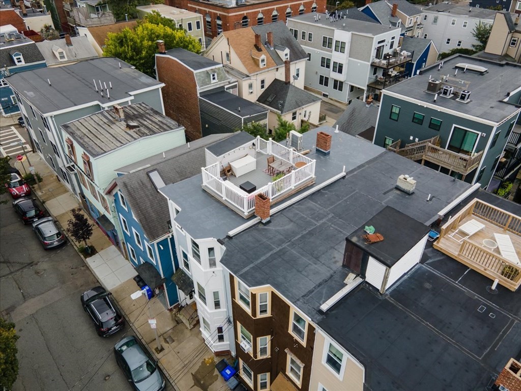 245 West Fifth Street, Unit 2 Boston, MA 02127 - Photo 32 of 34 an aerial view of a residential apartment building with a yard table and chairs