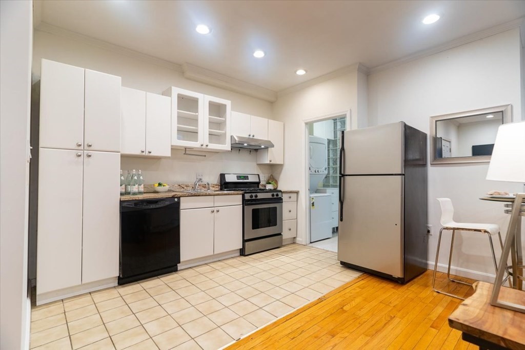 245 West Fifth Street, Unit 2 Boston, MA 02127 - Photo 7 of 34 a kitchen with a refrigerator a stove and white cabinets
