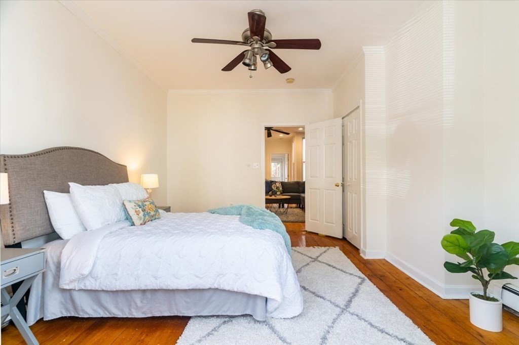 245 West Fifth Street, Unit 2 Boston, MA 02127 - Photo 10 of 34 a bedroom with a bed chandelier and a potted plant