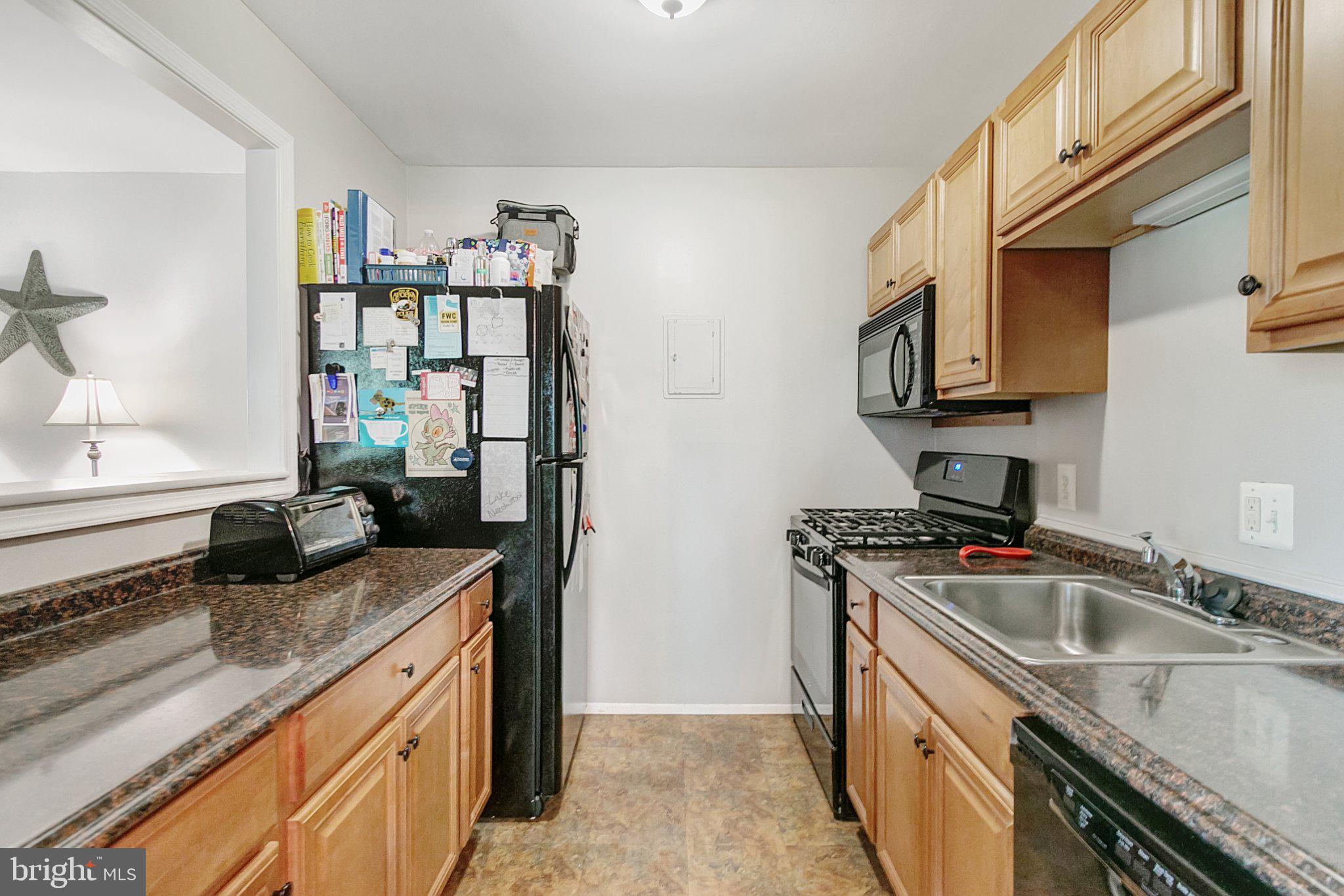3750 Bel Pre Road, Unit 11 Silver Spring, MD 20906 - Photo 11 of 27 a kitchen with stainless steel appliances granite countertop a sink stove and cabinets