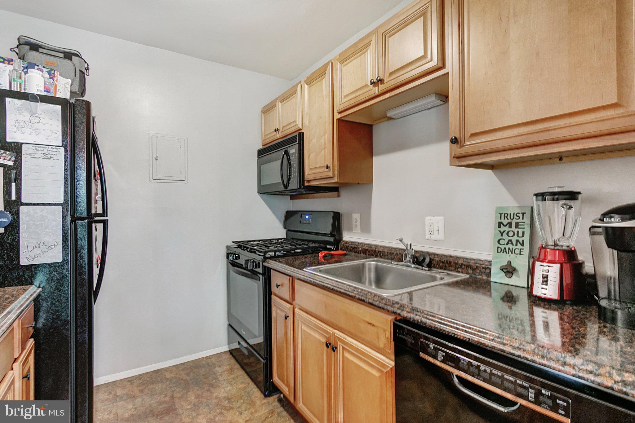 3750 Bel Pre Road, Unit 11 Silver Spring, MD 20906 - Photo 12 of 27 a kitchen with stainless steel appliances granite countertop a sink stove and refrigerator