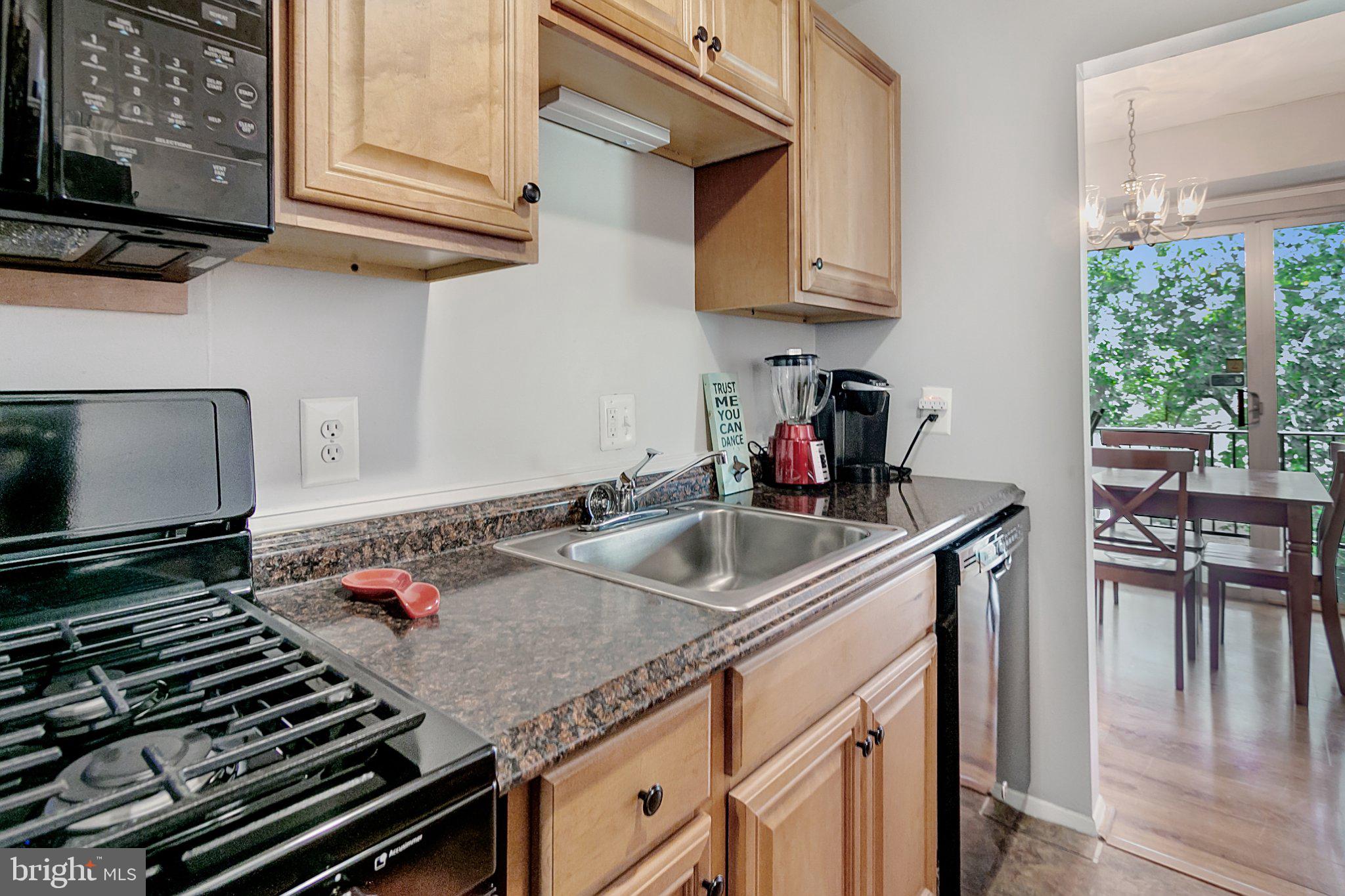 3750 Bel Pre Road, Unit 11 Silver Spring, MD 20906 - Photo 14 of 27 a kitchen with a sink stove and cabinets