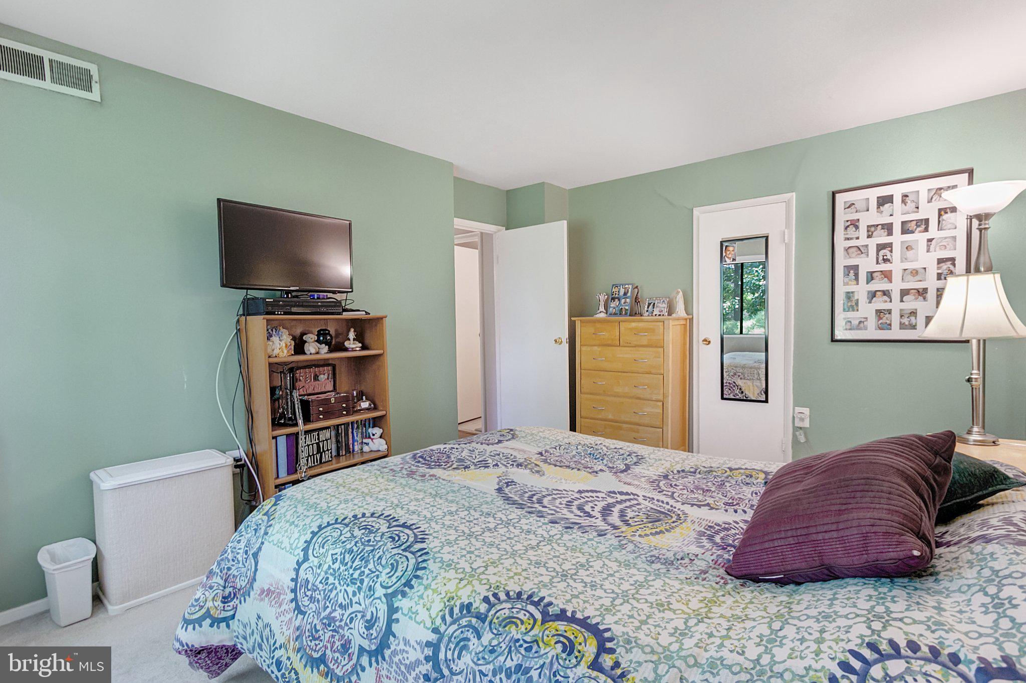 3750 Bel Pre Road, Unit 11 Silver Spring, MD 20906 - Photo 17 of 27 a bedroom with a bed and a flat screen tv