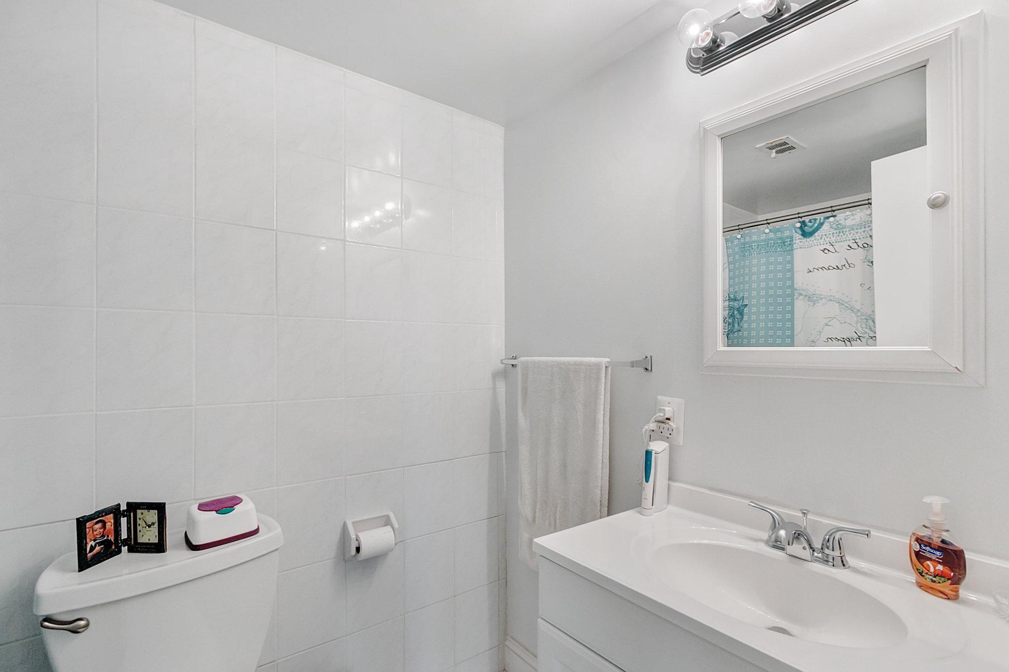 3750 Bel Pre Road, Unit 11 Silver Spring, MD 20906 - Photo 21 of 27 a bathroom with a sink vanity mirror and toilet