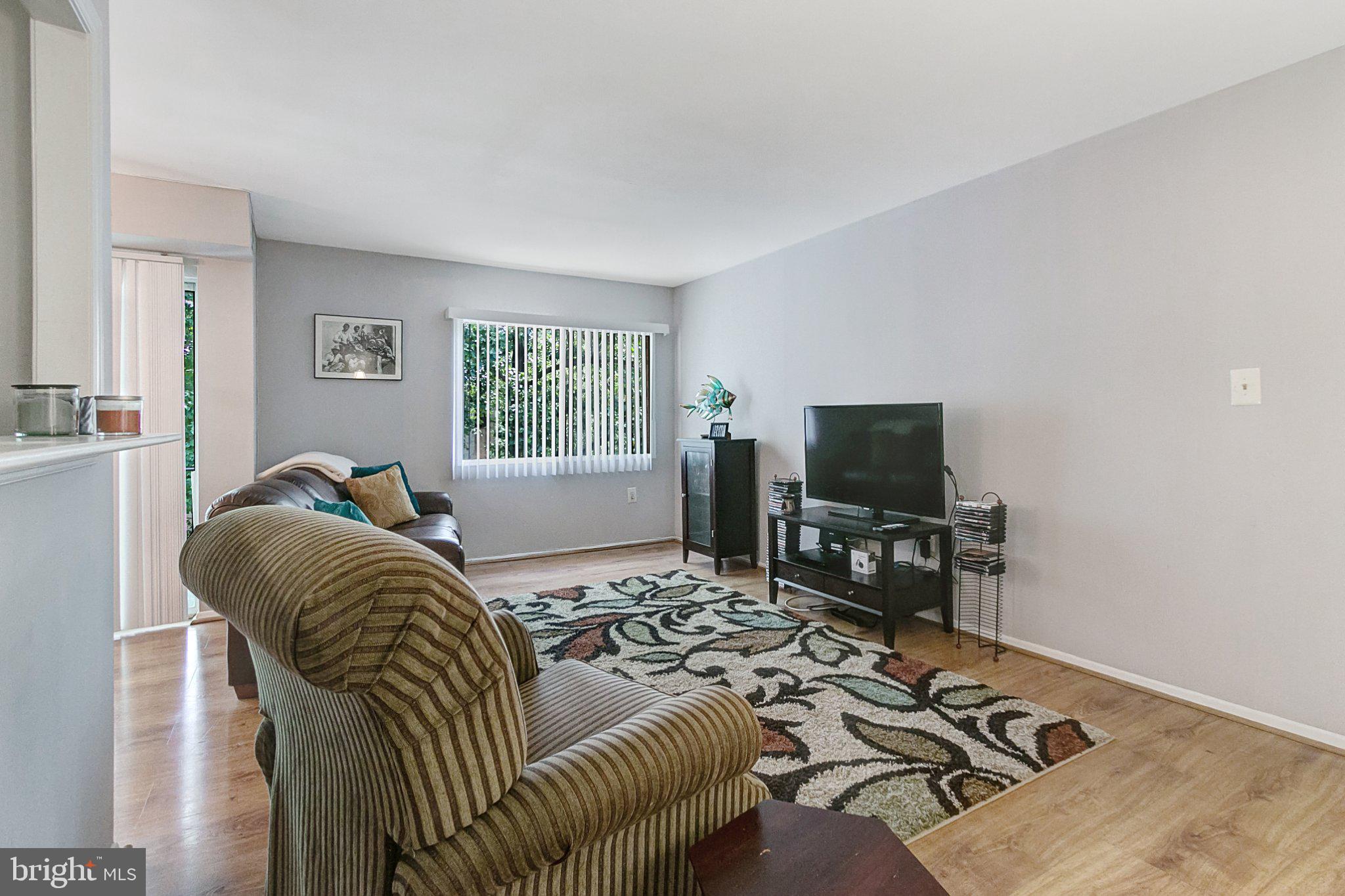 3750 Bel Pre Road, Unit 11 Silver Spring, MD 20906 - Photo 4 of 27 a bedroom with furniture and a flat screen tv