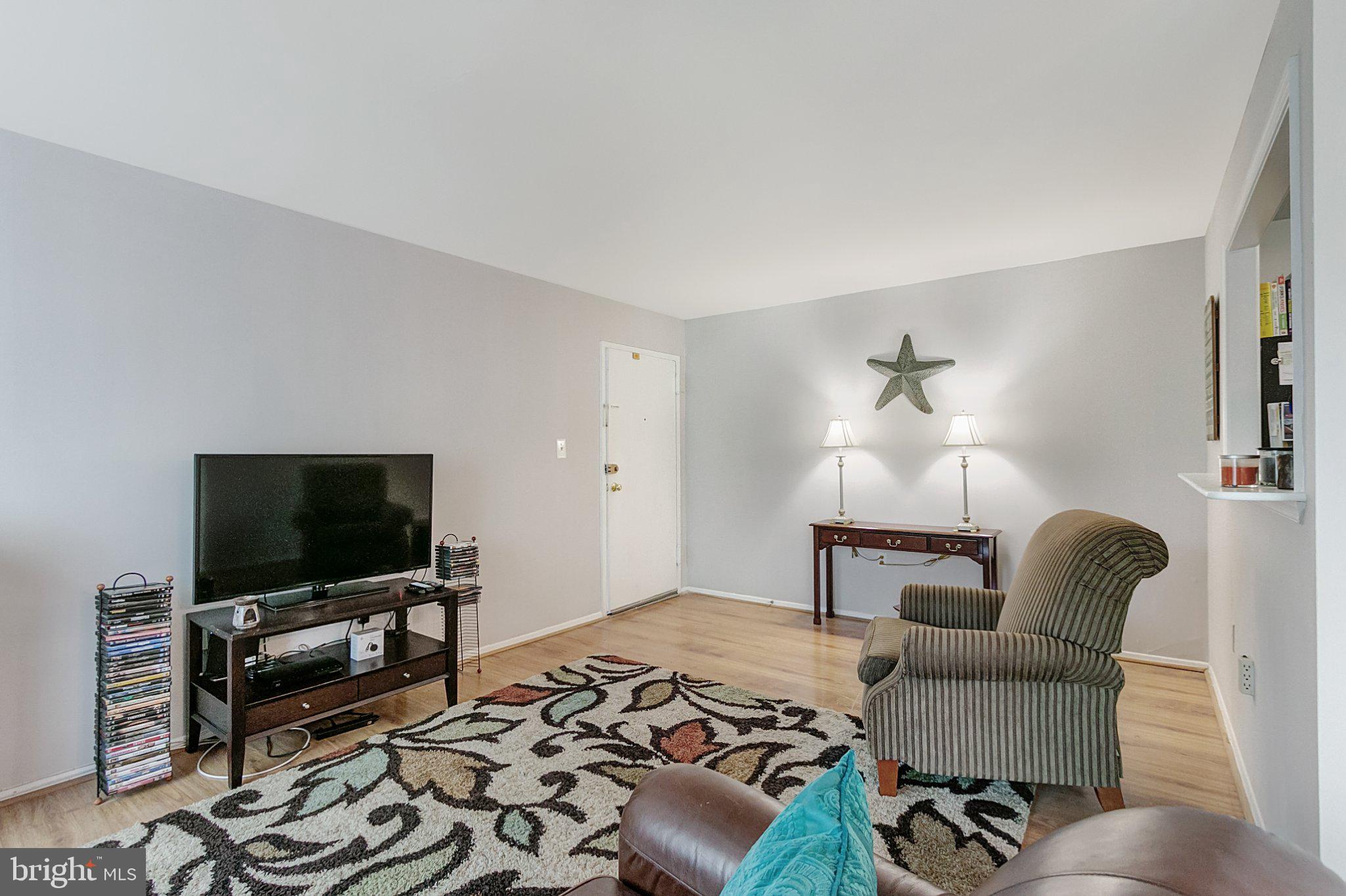 3750 Bel Pre Road, Unit 11 Silver Spring, MD 20906 - Photo 5 of 27 a living room with furniture and a flat screen tv