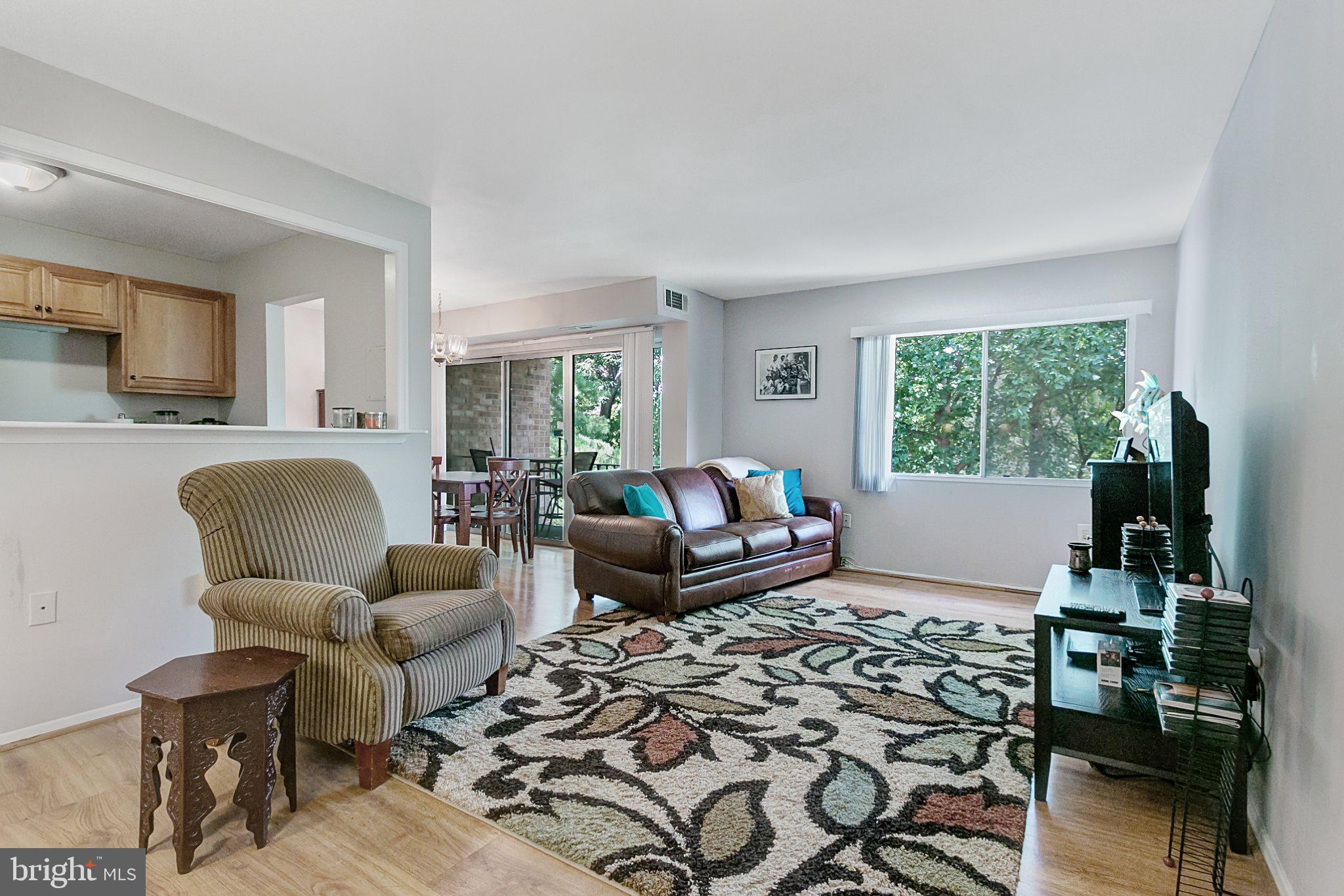 3750 Bel Pre Road, Unit 11 Silver Spring, MD 20906 - Photo 6 of 27 a living room with furniture and a flat screen tv