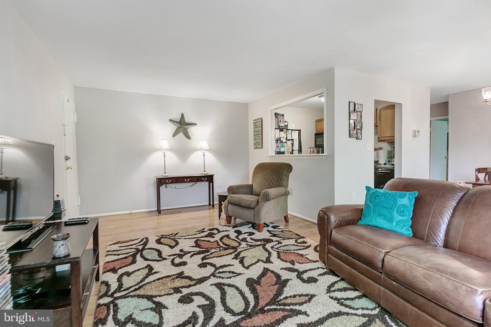 3750 Bel Pre Road, Unit 11 Silver Spring, MD 20906 - Photo 7 of 27 a living room with furniture and wooden floor