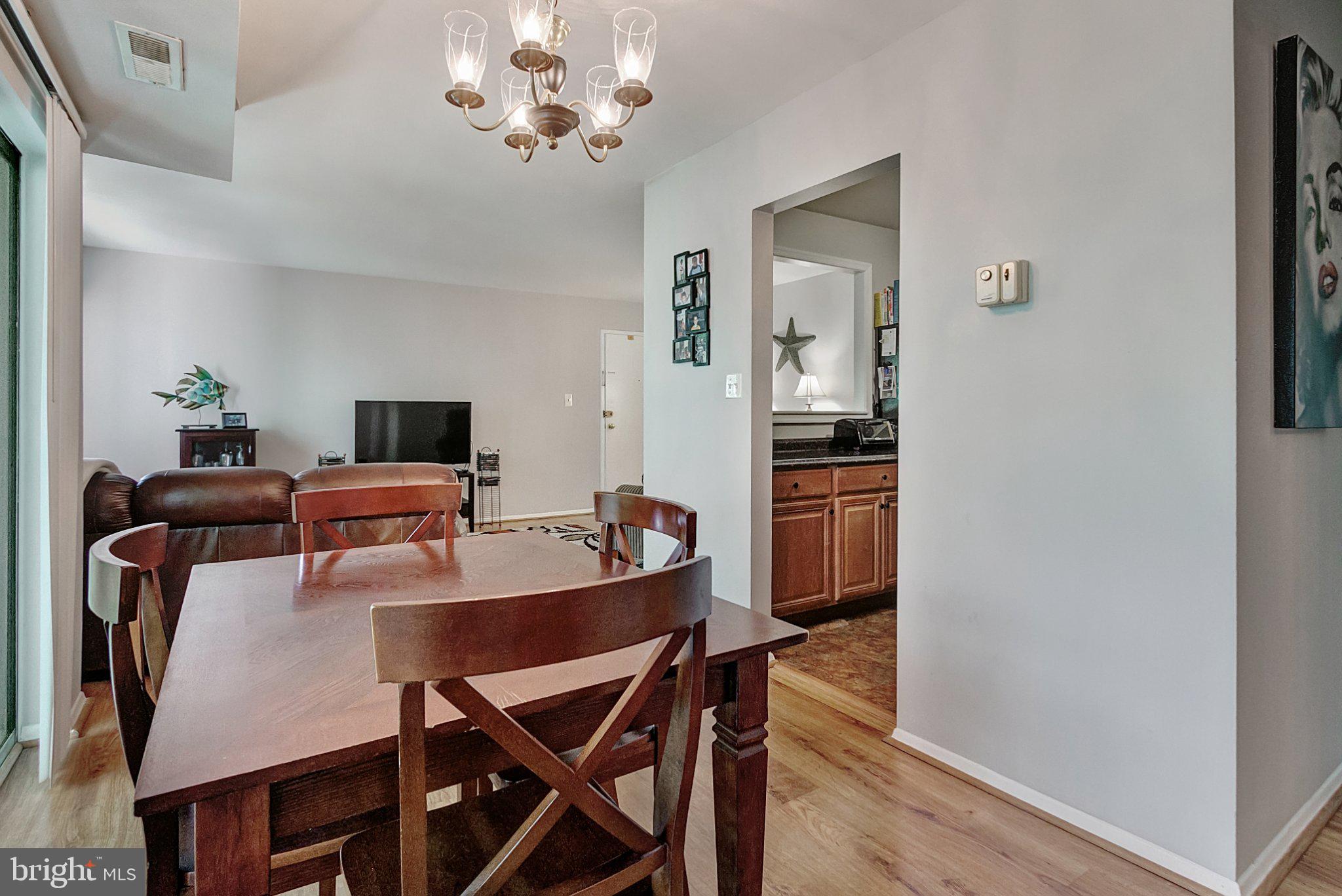 3750 Bel Pre Road, Unit 11 Silver Spring, MD 20906 - Photo 9 of 27 a view of a dining room with furniture and wooden floor