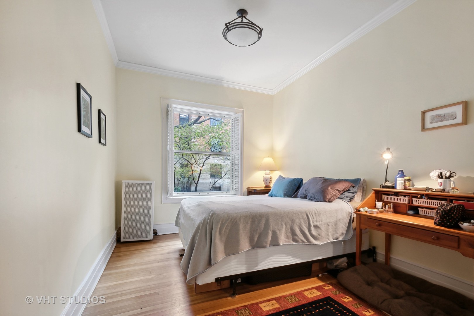 672 West Irving Park Road, Unit G1 Chicago, IL 60613 - Photo 12 of 19 a bedroom with a bed and wooden floor