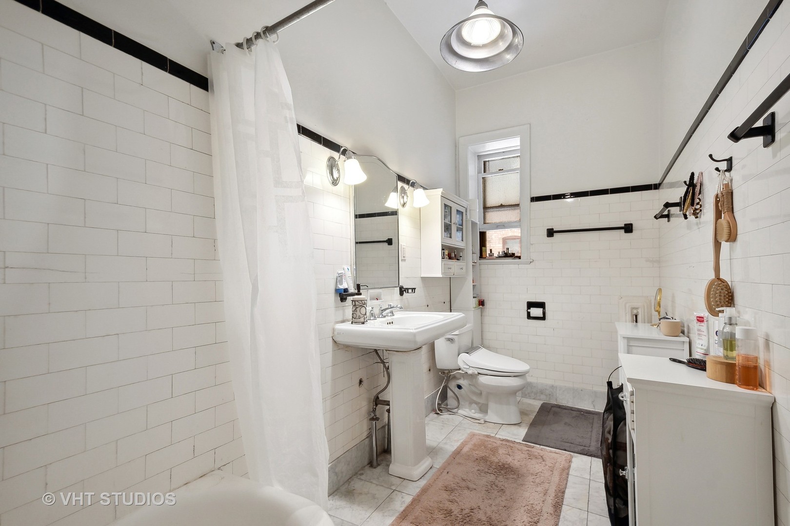 672 West Irving Park Road, Unit G1 Chicago, IL 60613 - Photo 13 of 19 a bathroom with a sink a toilet and shower