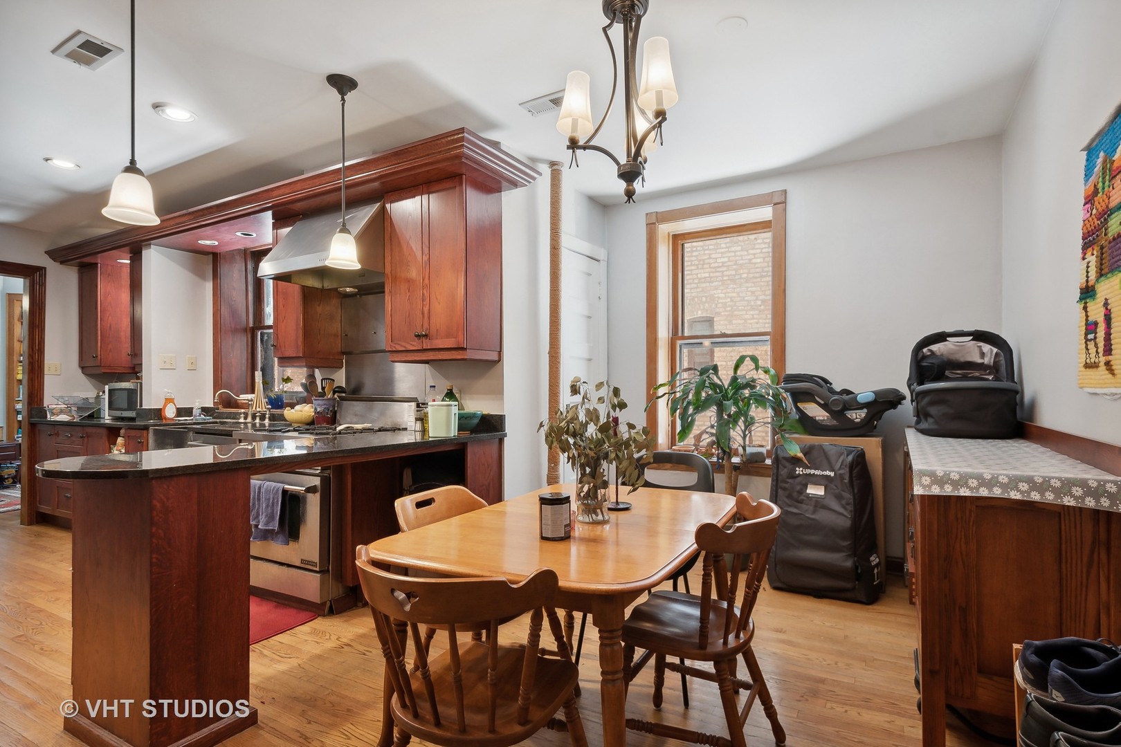672 West Irving Park Road, Unit G1 Chicago, IL 60613 - Photo 9 of 19 a kitchen with a table chairs and white cabinets