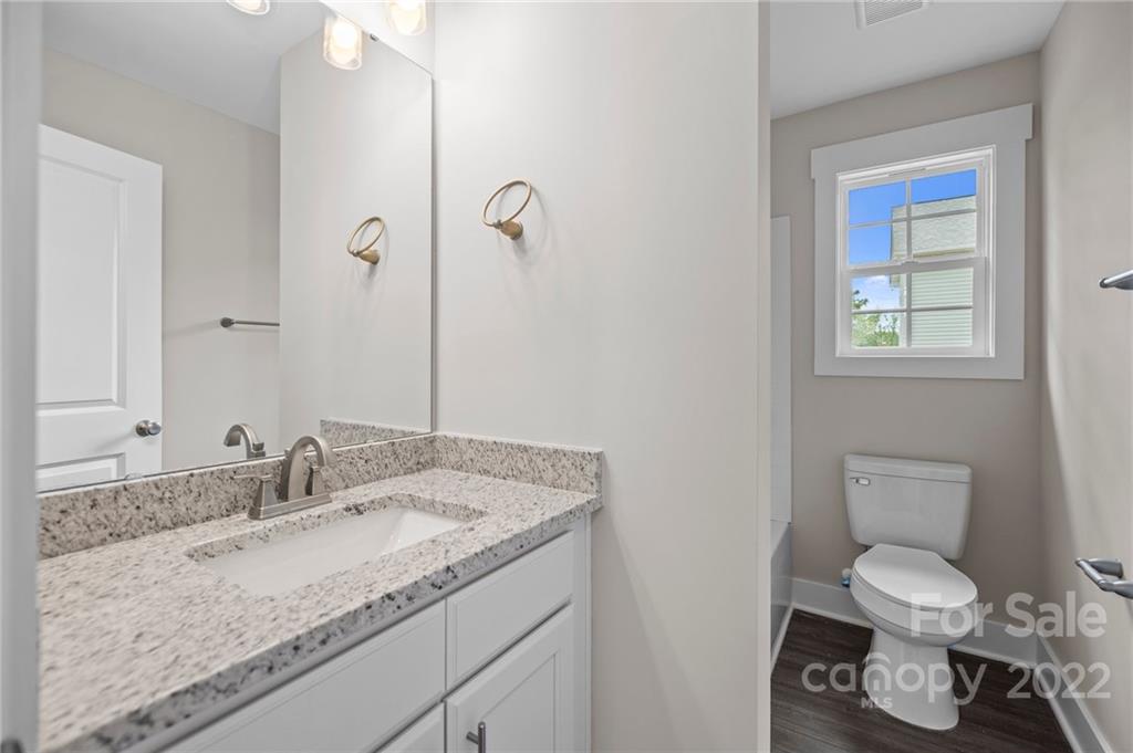 955 Pine Ridge Road, Unit 5 Chester, SC 29706 - Photo 19 of 26 a bathroom with a granite countertop sink a toilet and a mirror