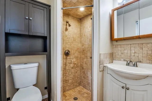 a bathroom with a toilet sink and shower