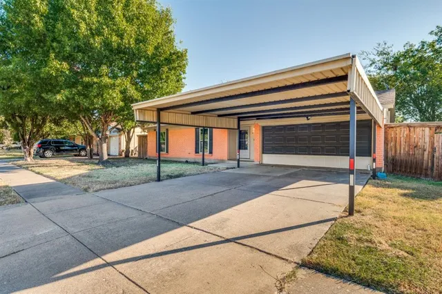 a view of house with outdoor space and trees