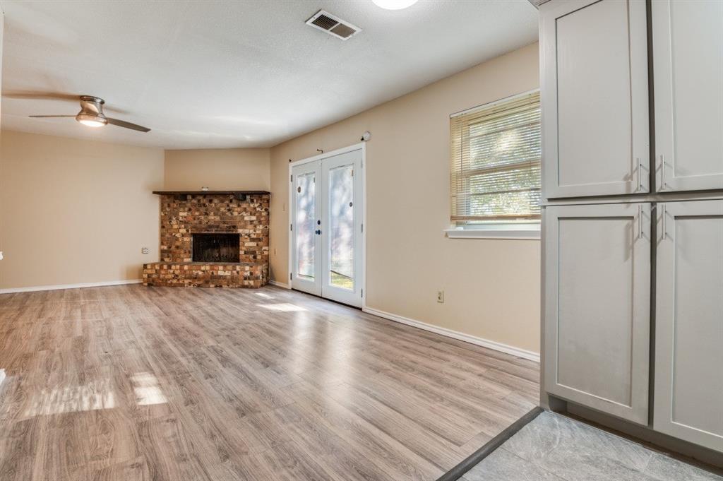 628 Thompson Street Everman, TX 76140 - Photo 8 of 24 an empty room with windows and fireplace