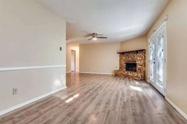 wooden floor in an empty room with a fireplace