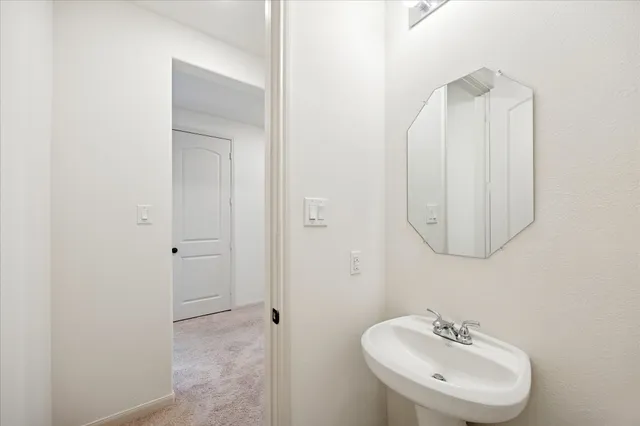 a open kitchen with white cabinets and stainless steel appliances