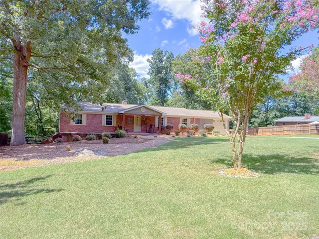 a view of a house with backyard sitting area and garden