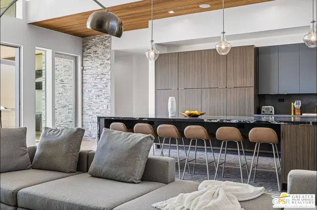 a living room with furniture a ceiling fan and a rug