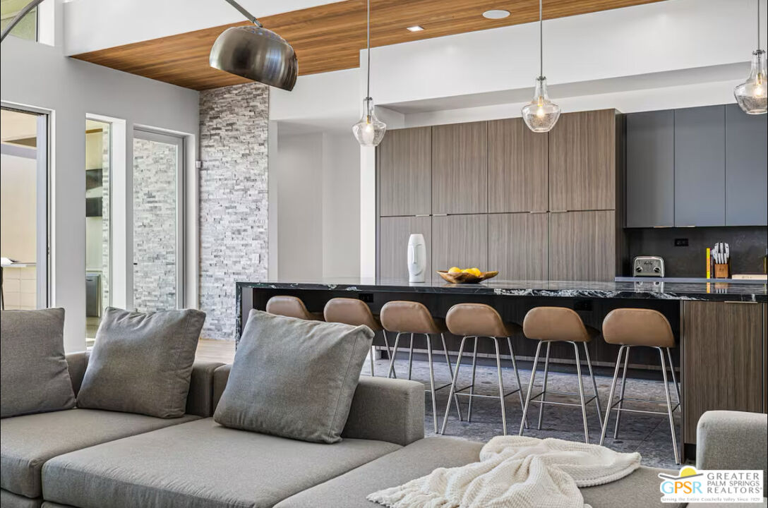 a living room with furniture a ceiling fan and a rug