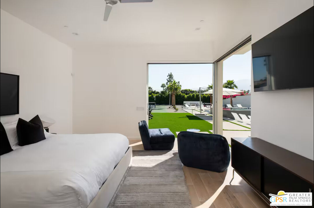 80883 Elemento Lane Indio, CA 92201 - Photo 11 of 47 a bed room with a bed television and a large window