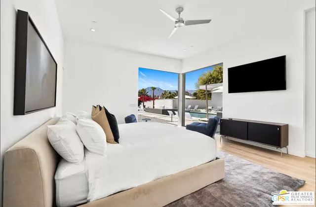 a bedroom with a bed and a flat screen tv