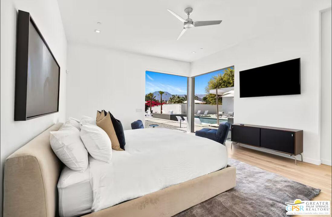 80883 Elemento Lane Indio, CA 92201 - Photo 13 of 47 a bedroom with a bed and a flat screen tv