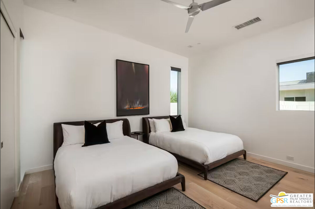 80883 Elemento Lane Indio, CA 92201 - Photo 15 of 47 a bedroom with two beds and painting on the wall