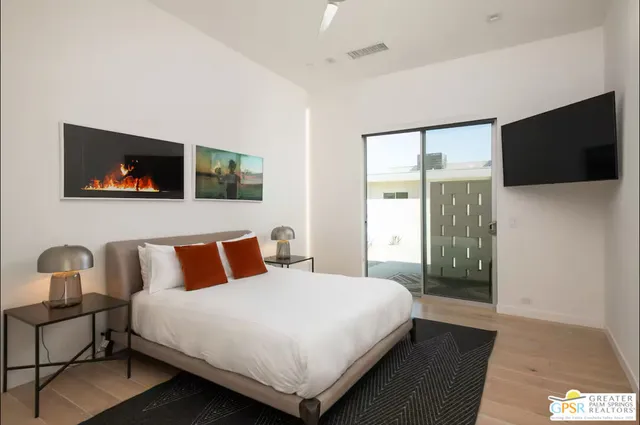 a bedroom with a bed and a flat screen tv