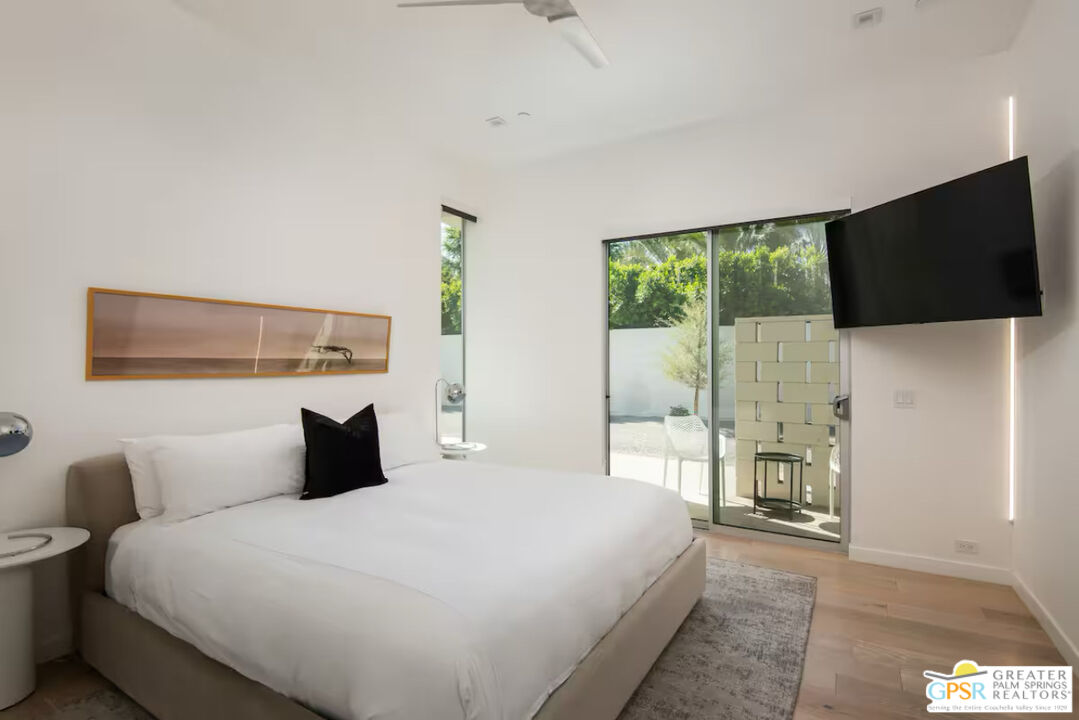 80883 Elemento Lane Indio, CA 92201 - Photo 19 of 47 a bedroom with a bed and a flat tv screen on the dresser