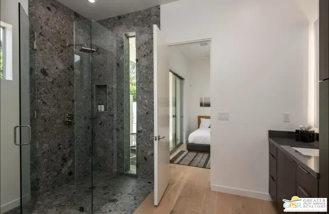 a bathroom with a shower and a sink