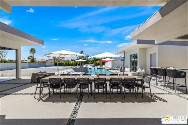 a view of a dining room with furniture and chandelier