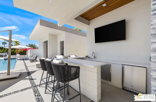 a view of a kitchen area with furniture and flat screen tv