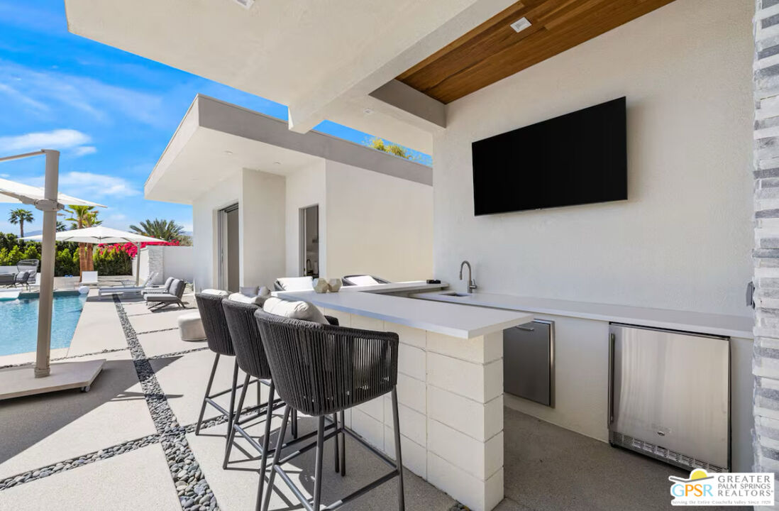 80883 Elemento Lane Indio, CA 92201 - Photo 27 of 47 a view of a kitchen area with furniture and flat screen tv