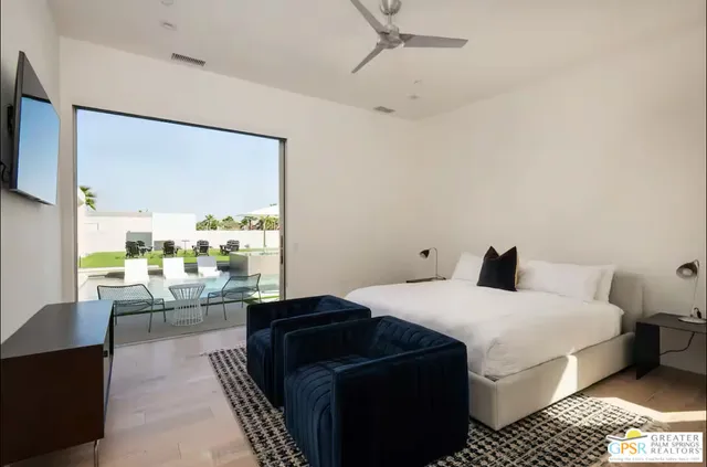 a bedroom with a bed and a large window