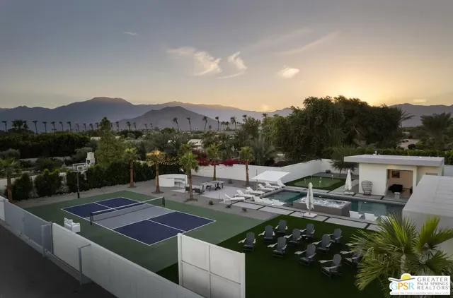 an aerial view of multiple houses with a yard