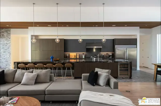 a living room with furniture and a kitchen view