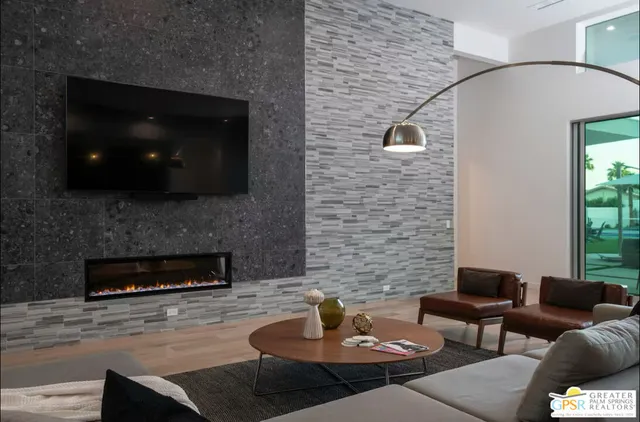 a living room with furniture and a fireplace