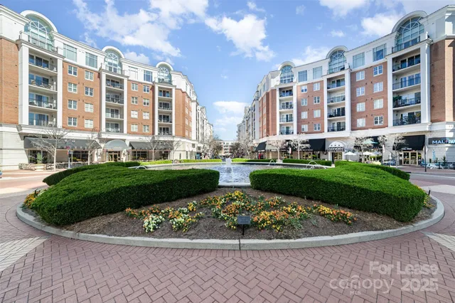 a view of a building with a yard and plants
