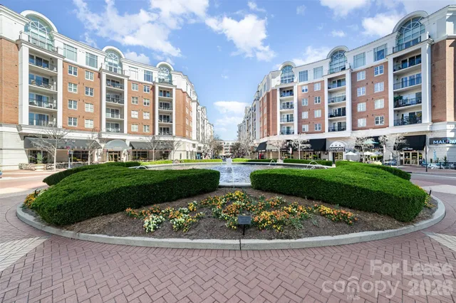 a view of a building with a yard and plants