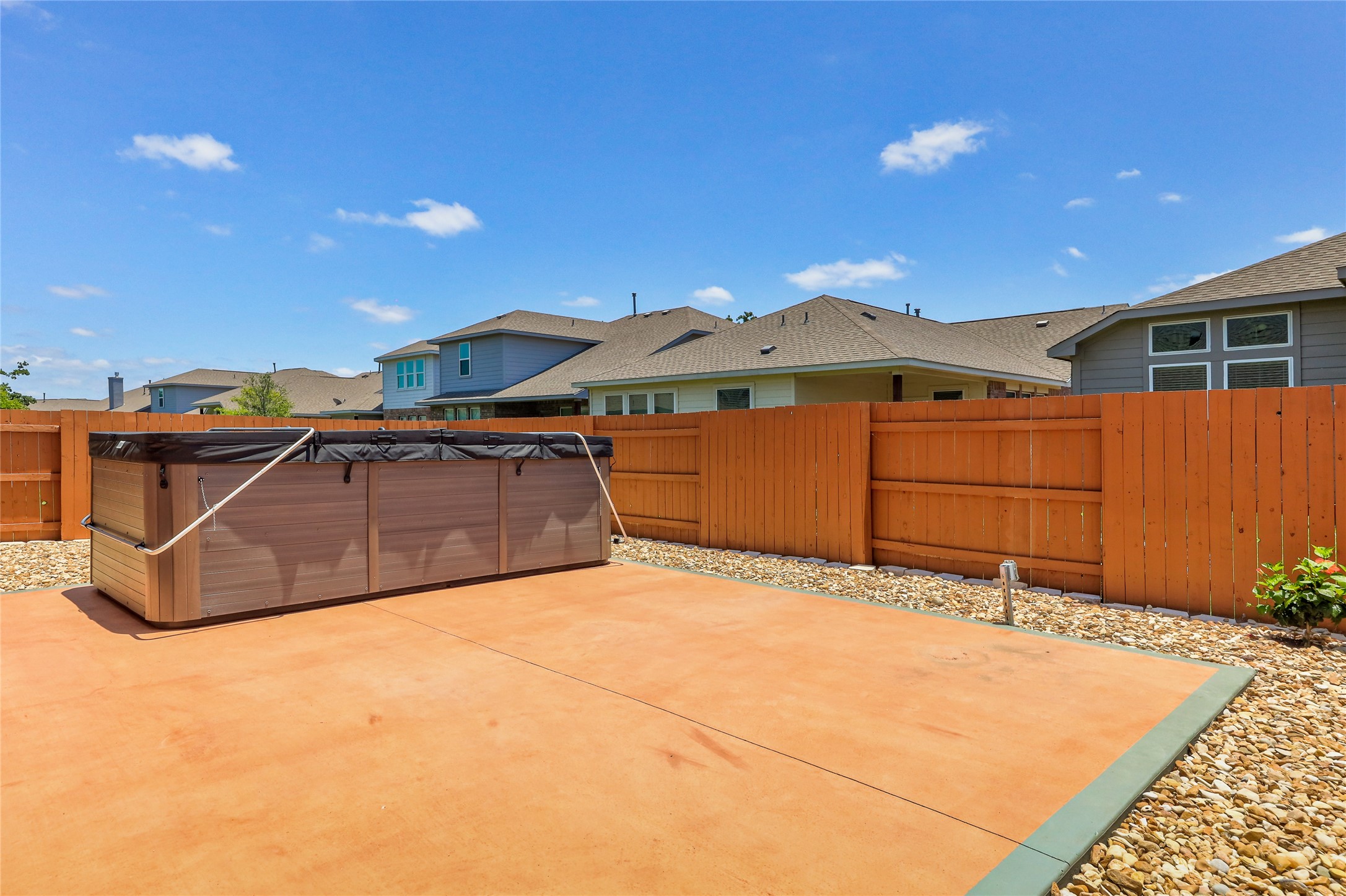 205 Penna Lane Georgetown, TX 78628 - Photo 29 of 32 A spacious backyard patio provides ample room for outdoor entertaining, complete with a private spa for relaxation.